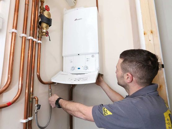 Gas Safe engineer with boiler
